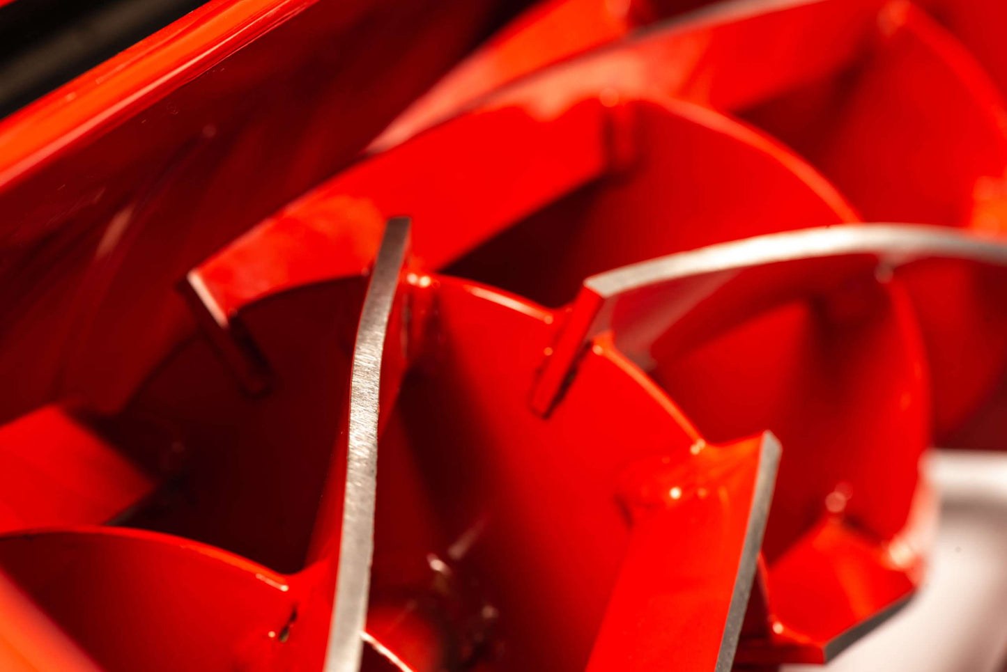 Close-up view of red blades inside the professional petrol cylinder mower for efficient cutting