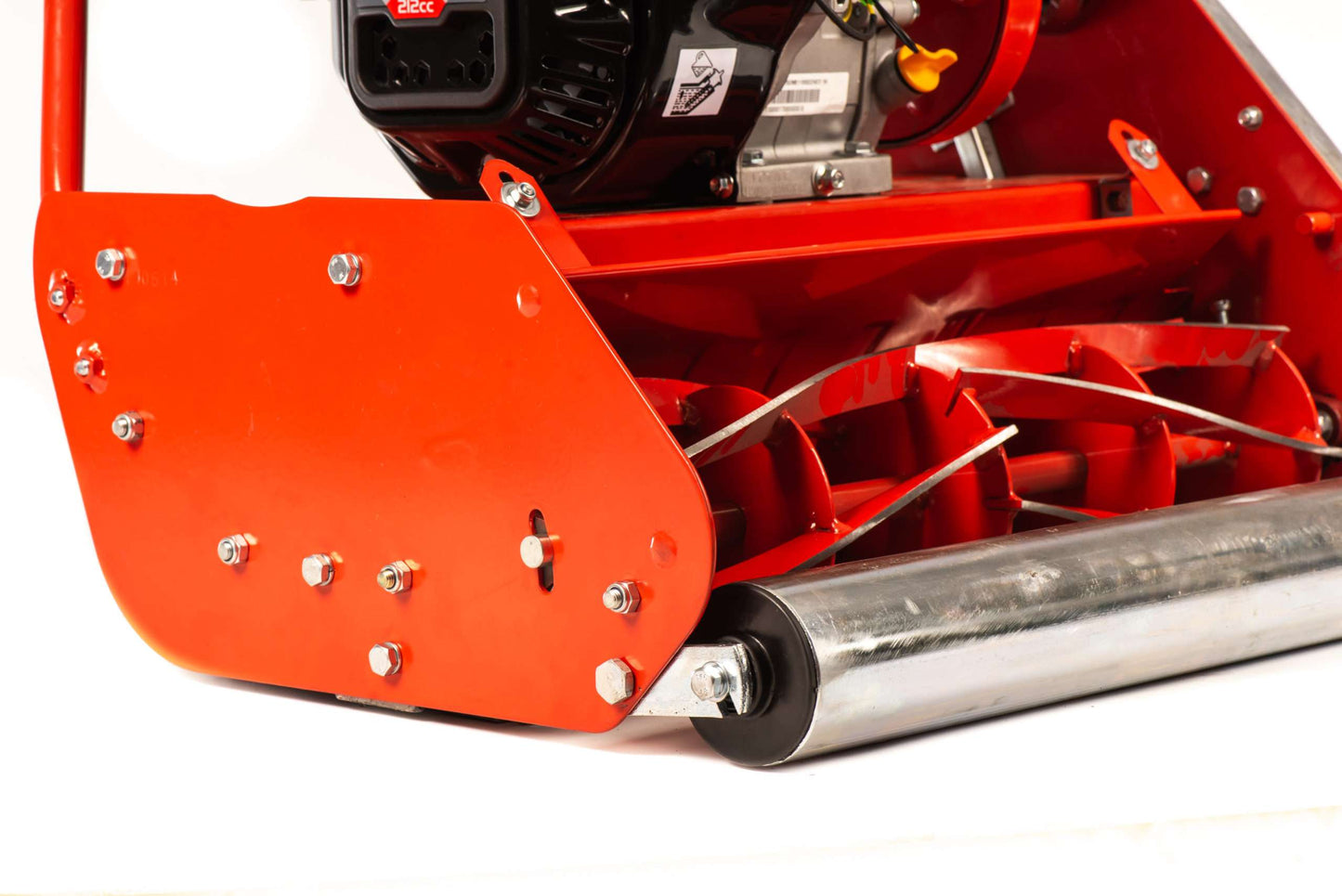 Close-up of professional petrol cylinder mower 14 inch red cutting blades and engine parts
