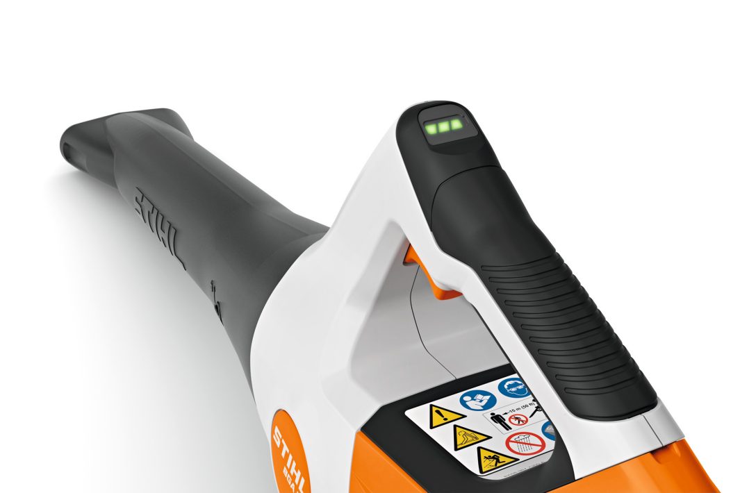 STIHL BGA30 cordless blower with ergonomic handle and safety warning labels in close-up view