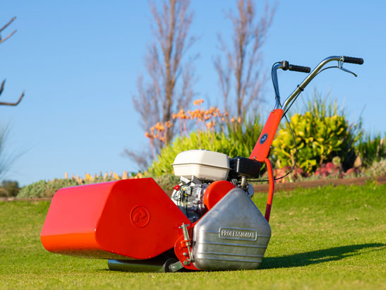 Red cylinder lawn mower with black handle and grass catcher for cylinder lawn mowers for sale