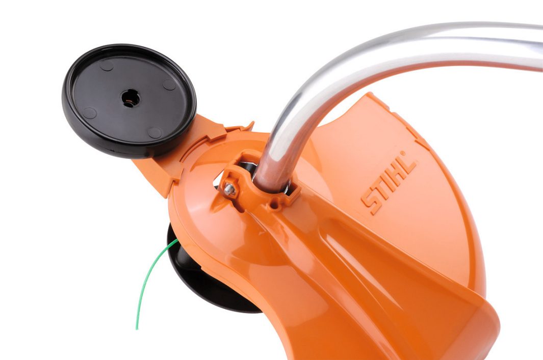 Close-up of STIHL FSE81 electric trimmer orange cutting head with guard and handle