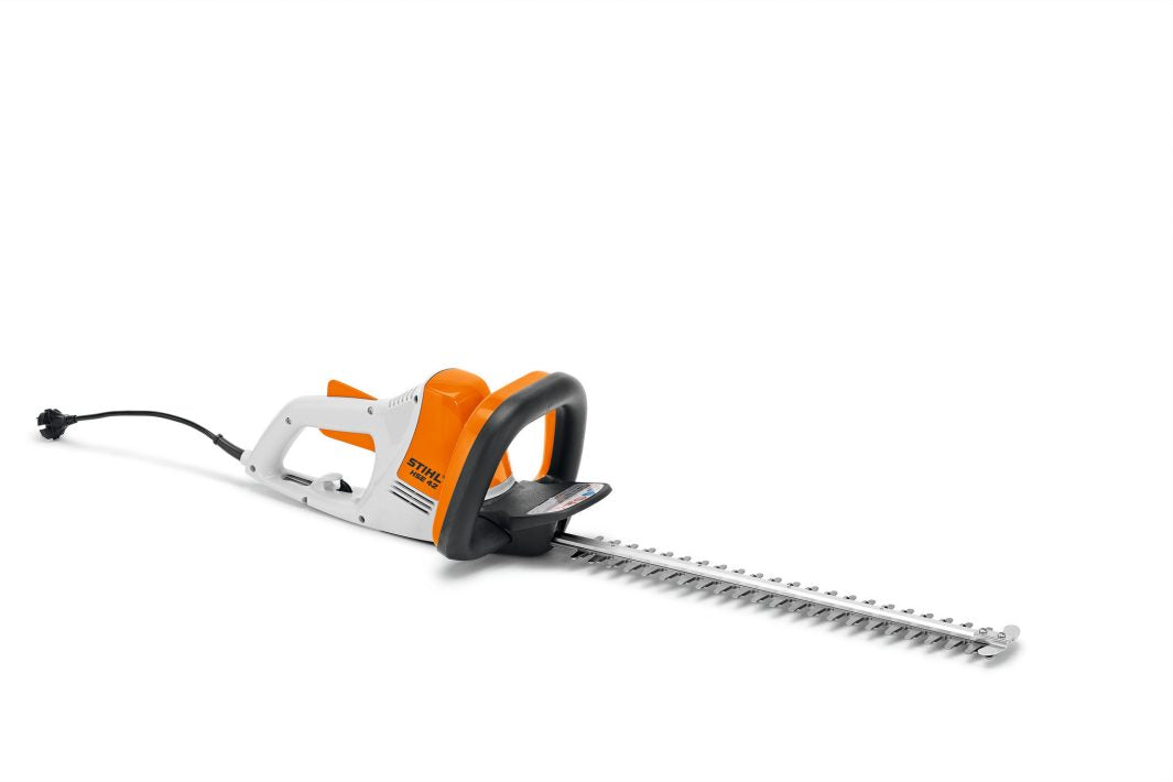 STIHL HSE42 hedge trimmer with orange and white body and long cutting blade for garden trimming